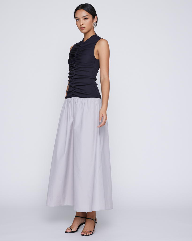 Modern ease combines with classic draping with this richly textured maxi dress. Cut in a finely woven cotton poplin, contrasted with ribbed jersey offering sleek comfort for any occasion. It's gathered sleeveless bodice flatters whilst a full drop waist skirt sweeps as you move. By Anna Quan, now available at After Eight. 