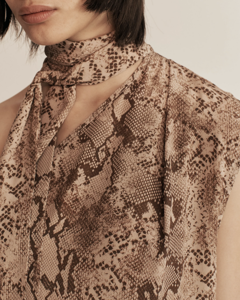 ESSE's new sultry and textural in-house designed python print is featured on this asymmetrical column maxi dress with built-in neck tie detail. By Esse, now available at After Eight. 
