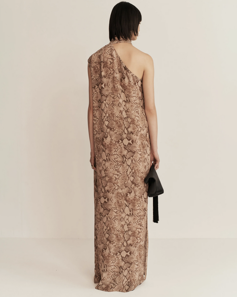 ESSE's new sultry and textural in-house designed python print is featured on this asymmetrical column maxi dress with built-in neck tie detail. By Esse, now available at After Eight. 