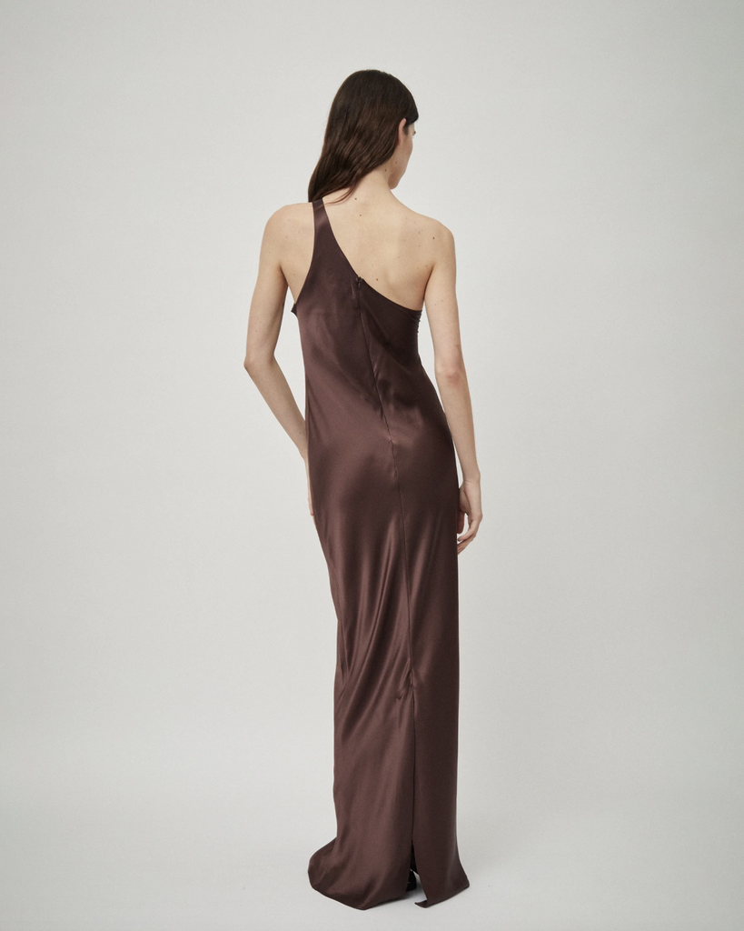 The One Shoulder Tank Dress in Raisin is a bias-cut silk satin tank dress with an asymmetric neckline and slim-line silhouette. Details an invisible zip closure and split hem. By Beare Park, now available at After Eight. 