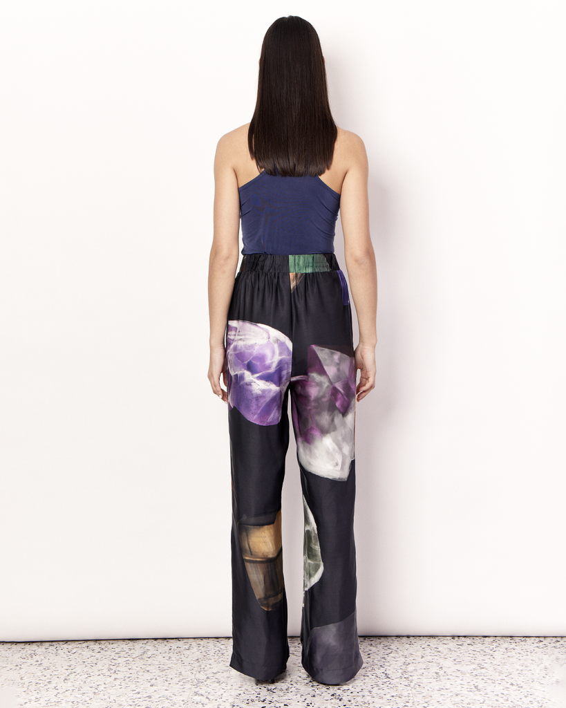 The Gemstone Pant features an elastic waistband and side pockets in our signature relaxed straight leg pant silhouette, offering an elevated yet comfortable style. It is crafted from a silky recycled Oeko-Tex® certified viscose in the opulent Gemstone Print, designed exclusively for Romy. Print placement will vary. By Romy, now available at After Eight. 