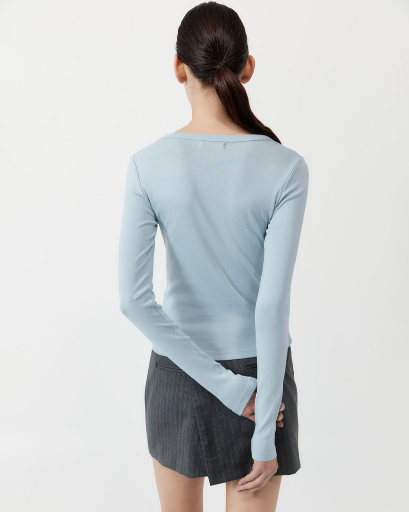 A slim-line minimalist staple, the Organic Cotton Long Sleeve Top boasts a crew neckline, long-sleeve silhouette and 100% organic cotton construction. Designed to layer seamlessly with your capsule wardrobe, the Organic Cotton Long Sleeve Top elevates a classic basic in both look and feel. By St Agni, now available at After Eight. 