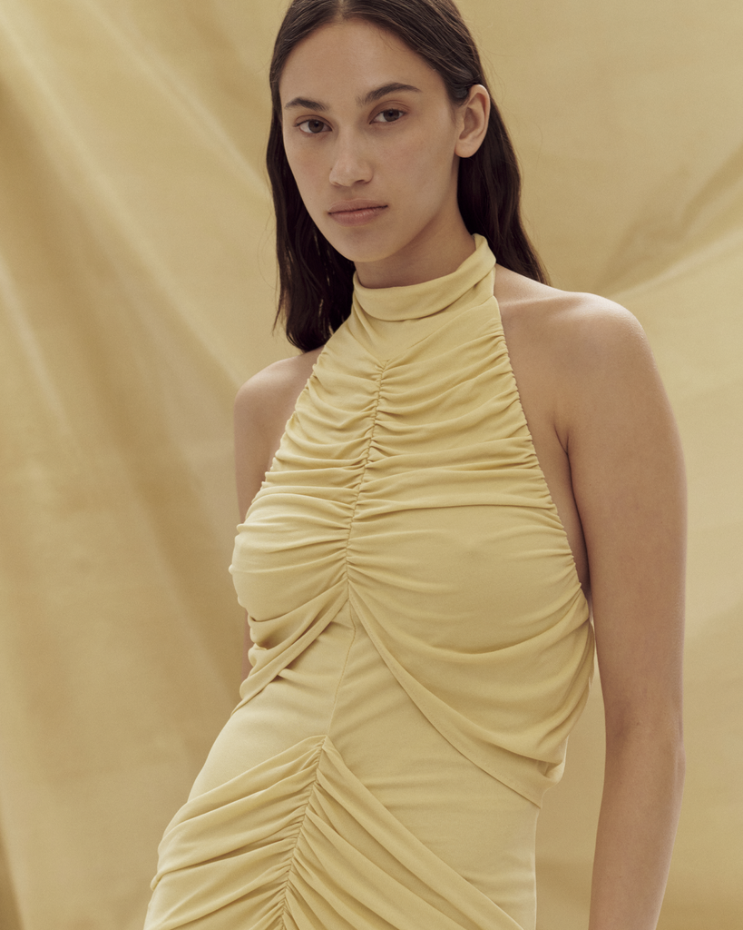 Made from a silky knit, the Roxie Dress is a show stopping gown, featuring a high neck, a slim fit and gathering through the front. By Paris Georgia, now available at After Eight. 