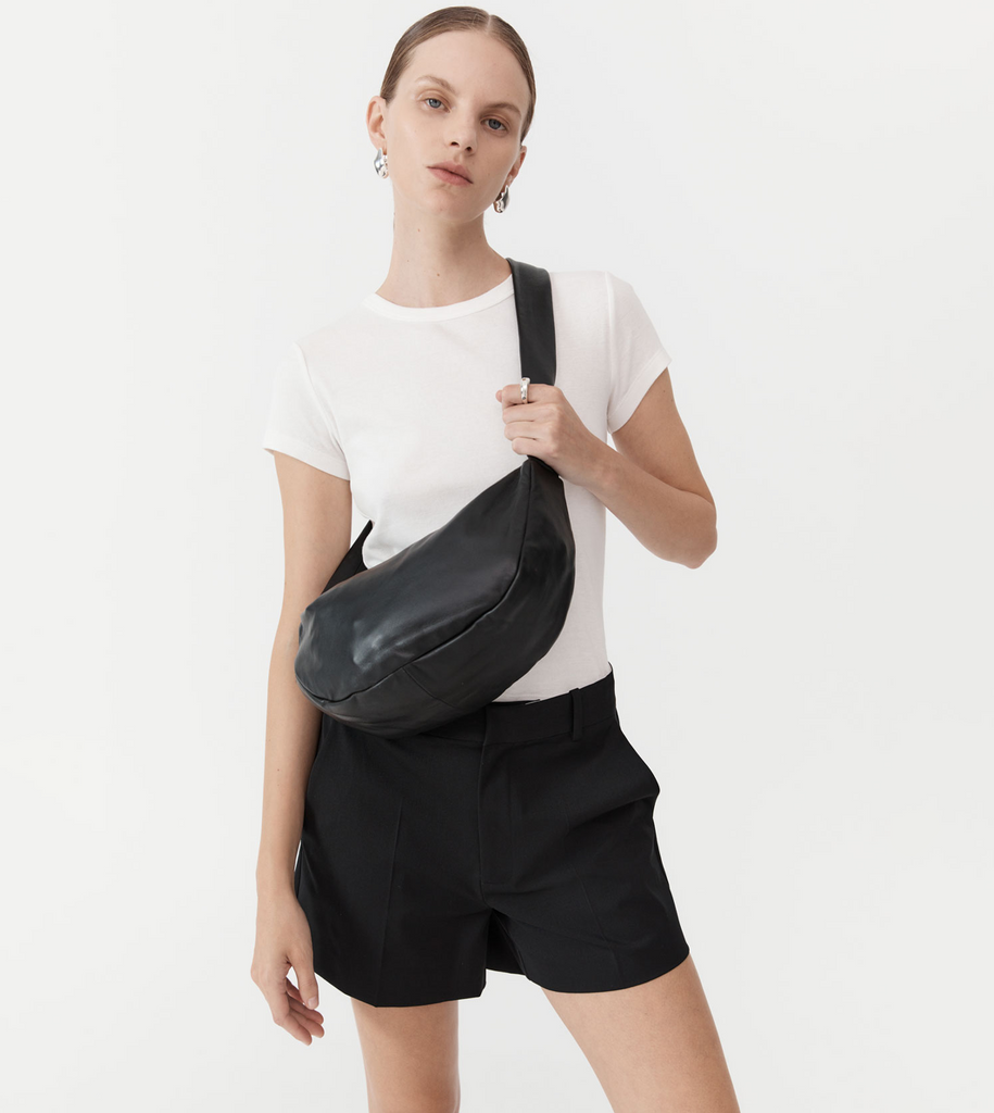 Soft and infinitely supple, the Soft Crescent Bag is for the modernist on the move. Crafted from a buttery 100% vegetable dyed lamb leather with a cotton lining, the Soft Crescent Bag is designed to be slung across the body for hands-free action. Boasting a croissant shaped body, thick strap and zip-up closure, perfect for home and travel alike. By St Agni, now available at After Eight. 