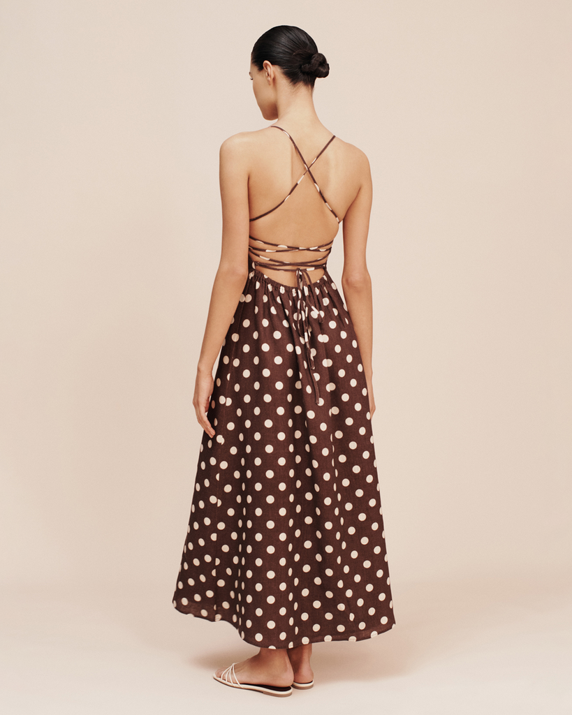 Patterned with classic polka-dots, The Lori Dress is a statement piece perfect for both day and evening wear. It features a flattering square neckline, elasticated back and free-flowing maxi skirt. It turns to reveal a stunning open back with an adjustable tie feature. By Posse, now available at After Eight. 