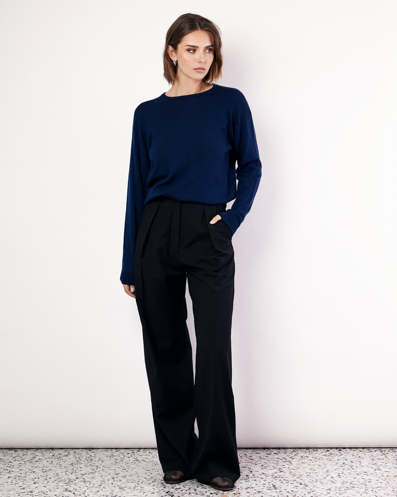 The Crew Neck Sweater is an everyday lightweight knit, featuring ribbed collar, cuff and hem detailing. It is crafted from 100% Extra Fine Merino Wool in Navy. By Romy, now available at After Eight. 