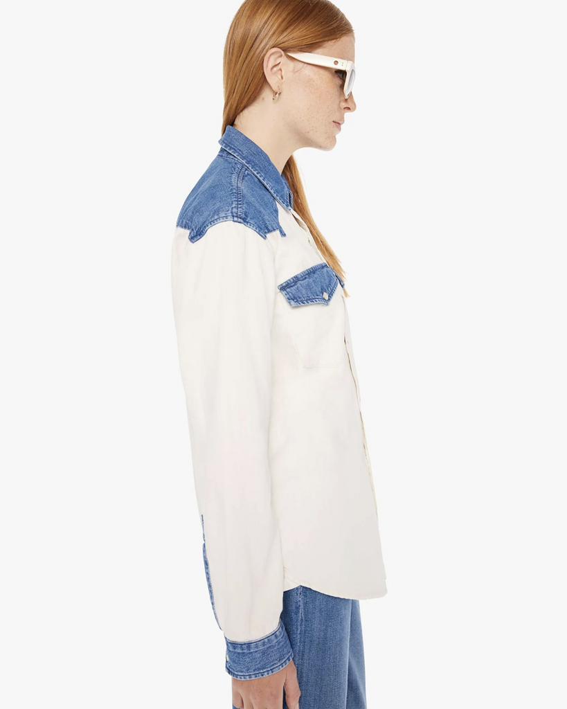 A Western-inspired denim button-up with patch pockets, a curved hem, and snaps down the front. Made from 100% cotton, the Tycoon in Shoulder To Shoulder is designed in off white with denim details at the shoulders, pockets and wrists. By Mother Denim, now available at After Eight. 