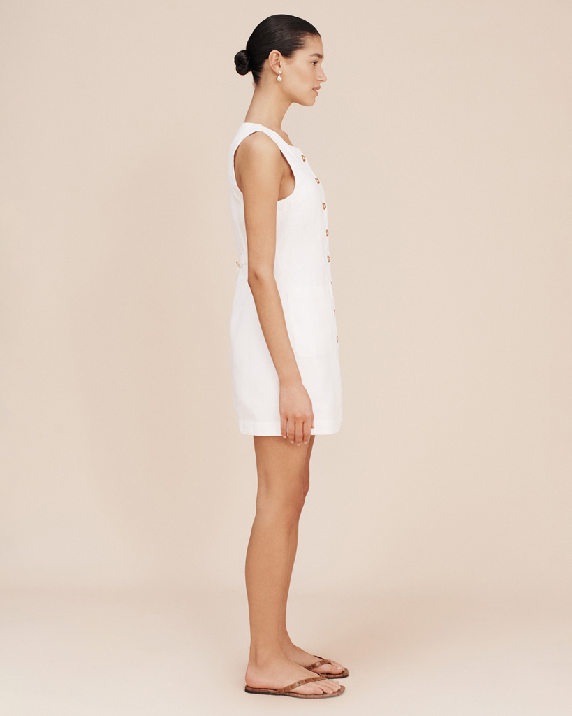 An adaptation of the beloved Emma Vest, The Emma Mini Dress is crafted from 100% linen and is perfect for both day and evening wear. It features an elegant high neck, centre front button fastenings and a curved hem. It has an adjustable buckle at the back to cinch in the waist and tailor the fit. By Posse, now available at After Eight. 