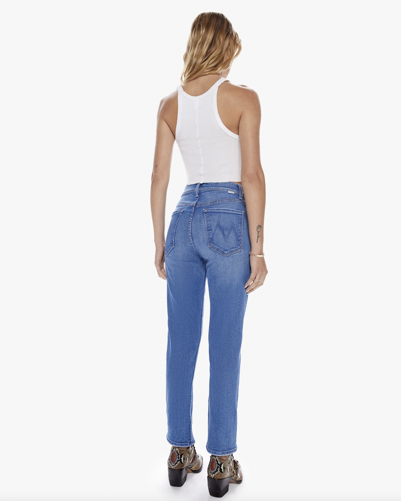 The Mother bestselling high-rise straight leg with a button fly and a cropped inseam. Made from denim with a touch of stretch, Layover is a bright mid-blue wash with whiskering and fading throughout. By Mother Denim, now available at After Eight. 