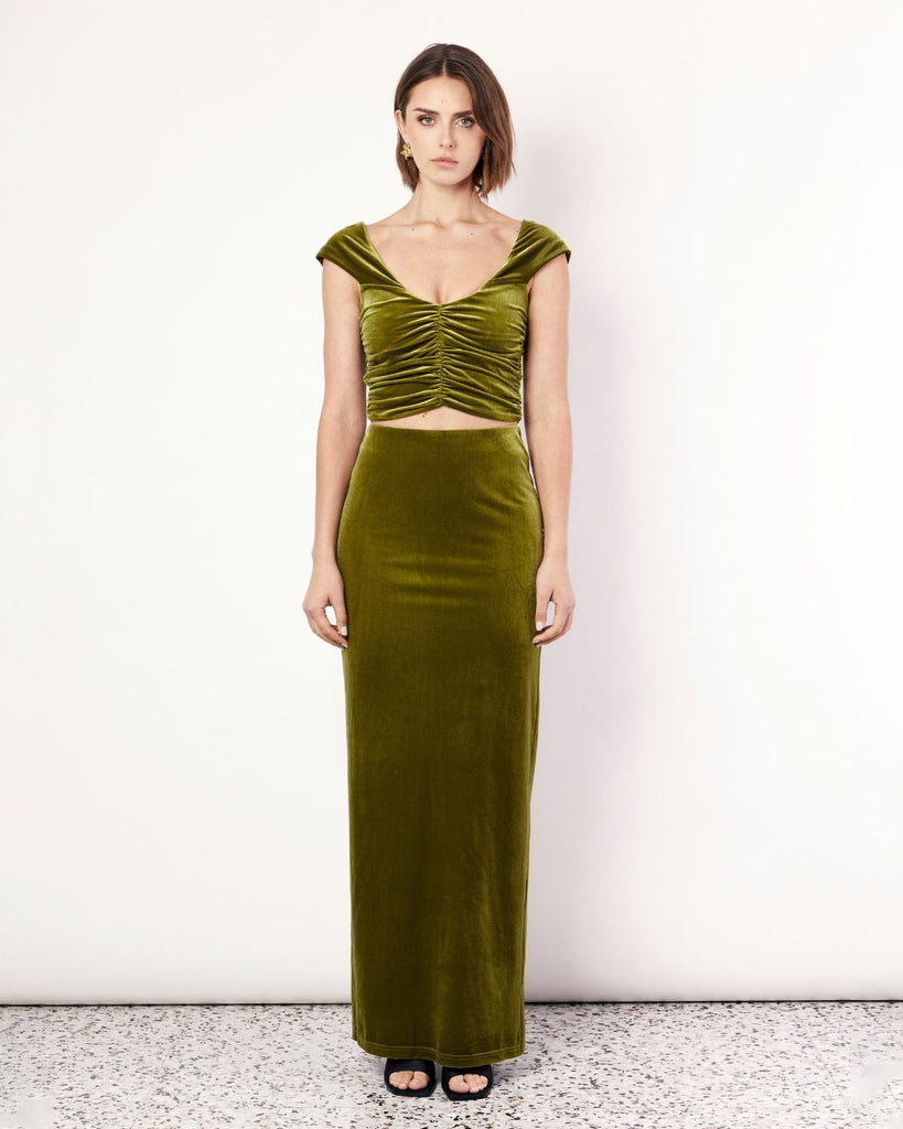The Velvet Maxi Skirt is a figure hugging silhouette that falls to an elegant maxi length. It has an elastic waistband and is crafted from a plush stretch Velvet fabrication in a stunning green hue. By Romy, now available at After Eight. 