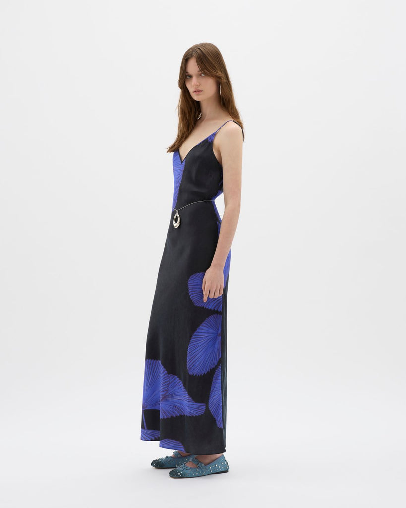 A timeless staple with a contemporary edge, the Yin Night Palms Bias Maxi dress is a seasonal favourite. Made in a lustrous, biodegradable vegan cupro exemplifying effortless style, its design ensures that it sits above the ephemeral trends of the decade. A gentle v at the neck and back, and bias in nature, a silhouette-defining piece. Adjustable straps and custom Muma hardware ensures it flatters any figure with ease. By Muma World, now available at After Eight. 