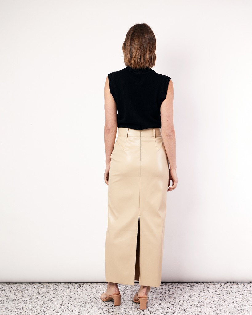 The best selling, Maxi Suiting Skirt has been recut for Fall in a buttery soft vegan leather. It features belt loops and a back split for ease of wear. By Romy, now available at After Eight. 