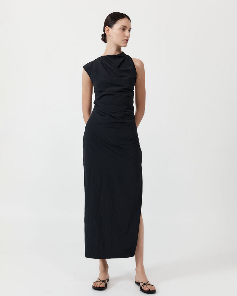 Inspired by a grecian drape, the Asymm Tuck Dress follows the natural shape of the 100% recycled nylon fabric. Crafted with an asymmetric neckline, ruched draping, cutout back and maxi length, the Asymm Tuck Dress cuts a slim, fitted silhouette for an elegant and elevated approach to styling. By St Agni, now available at After Eight. 