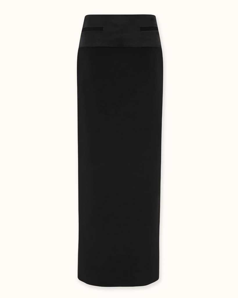 Modern column skirt with a subtle homage to a gentleman's tuxedo. Features a cummerbund inspired deep waistband in contrast satin fabrication. By Esse, now available at After Eight. 