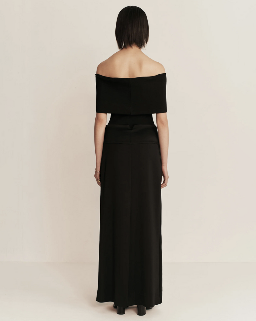 Modern column skirt with a subtle homage to a gentleman's tuxedo. Features a cummerbund inspired deep waistband in contrast satin fabrication. By Esse, now available at After Eight. 