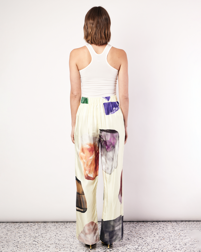 The Gemstone Pant features an updated waistband design that includes a flat band at the front and elastic at the back to flatter the figure. It features side pockets in our signature relaxed straight-leg pant silhouette, offering an elevated yet comfortable style. It is crafted from a silky recycled Oeko-Tex® certified viscose in the Gemstone Print, designed exclusively for Romy. By Romy, now available at After Eight. 