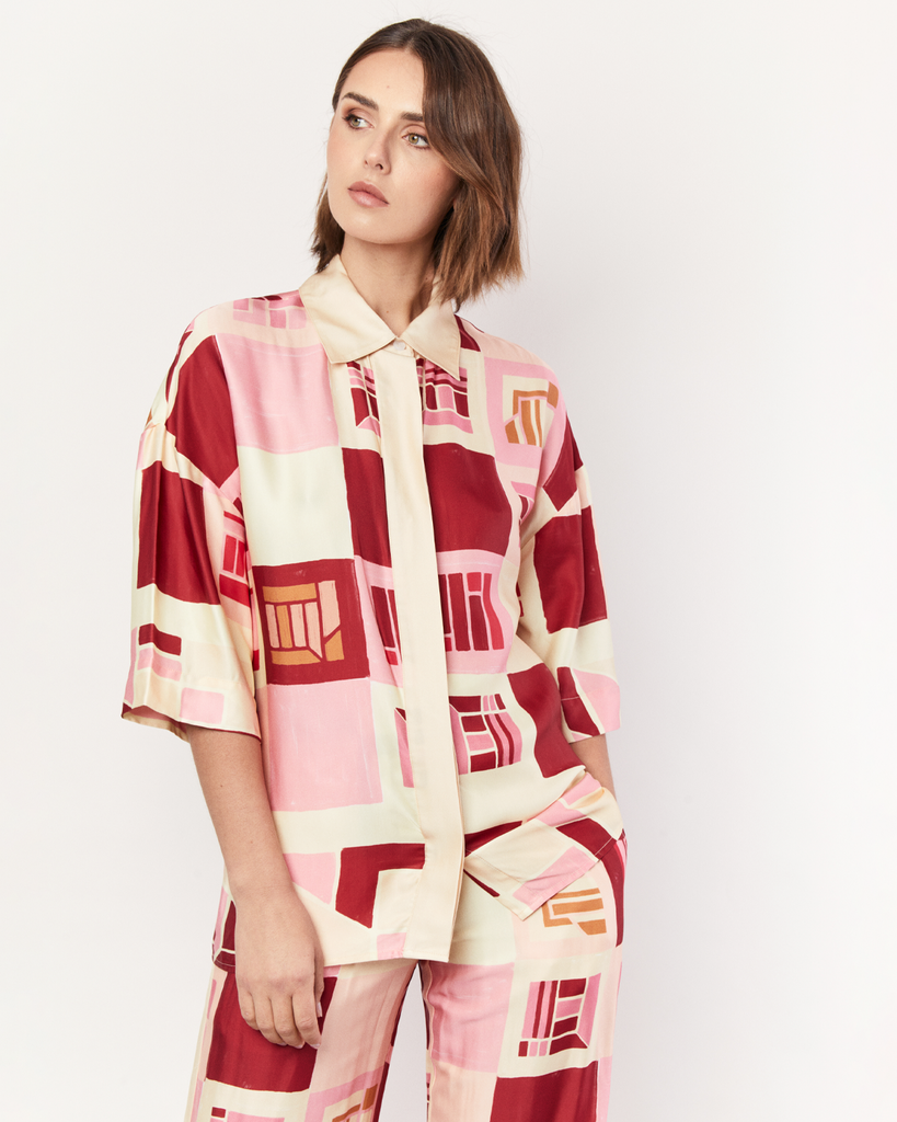 Designed for a relaxed fit, the Retro Shirt effortlessly combines comfort with laid-back style. It is crafted from a silky recycled Oeko-Tex® certified viscose in the Resort 24' retro-inspired print. By Romy, now available at After Eight. 