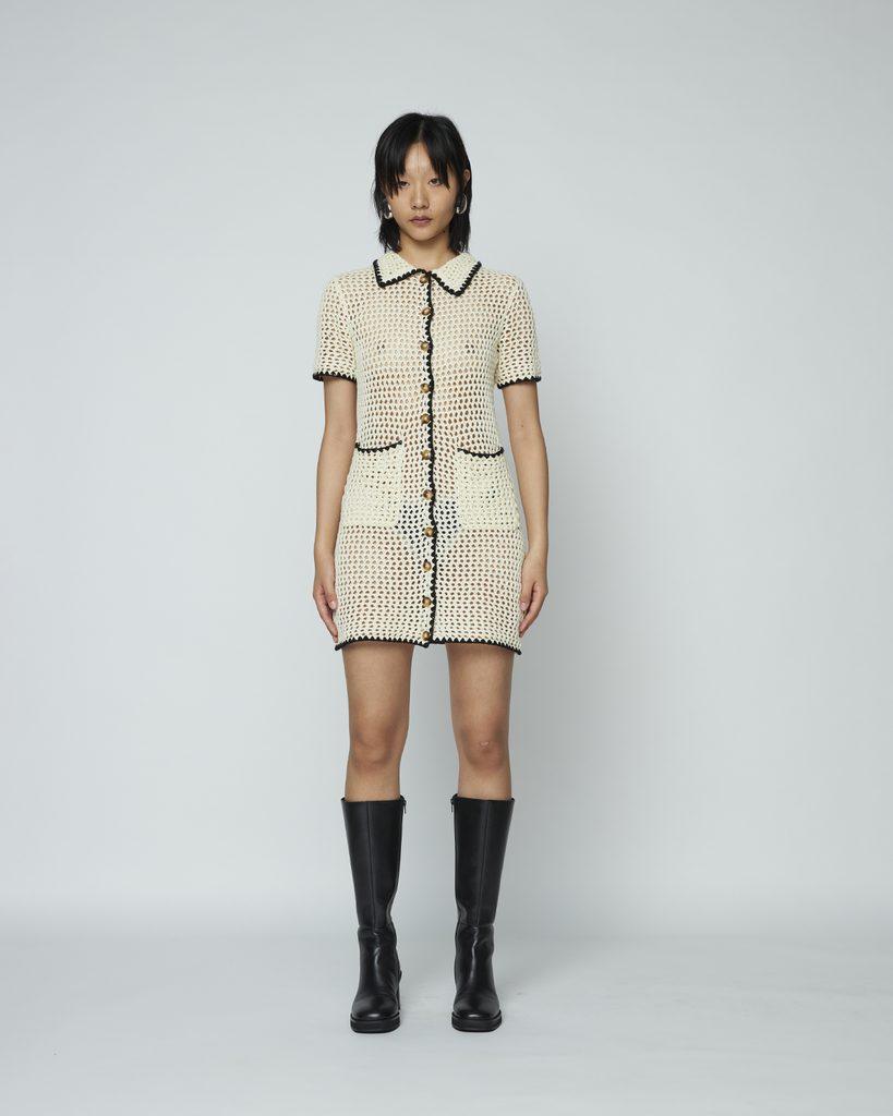 The Crochet Shirt Dress by Wynn Hamlyn is a short sleeve fitted mini dress with a spread collar. It features two front patch pockets, contrast detailing on collar, sleeve hem and down centre front and Wynn Hamlyn branded buttons. By Wynn Hamlyn, now available at After Eight. 