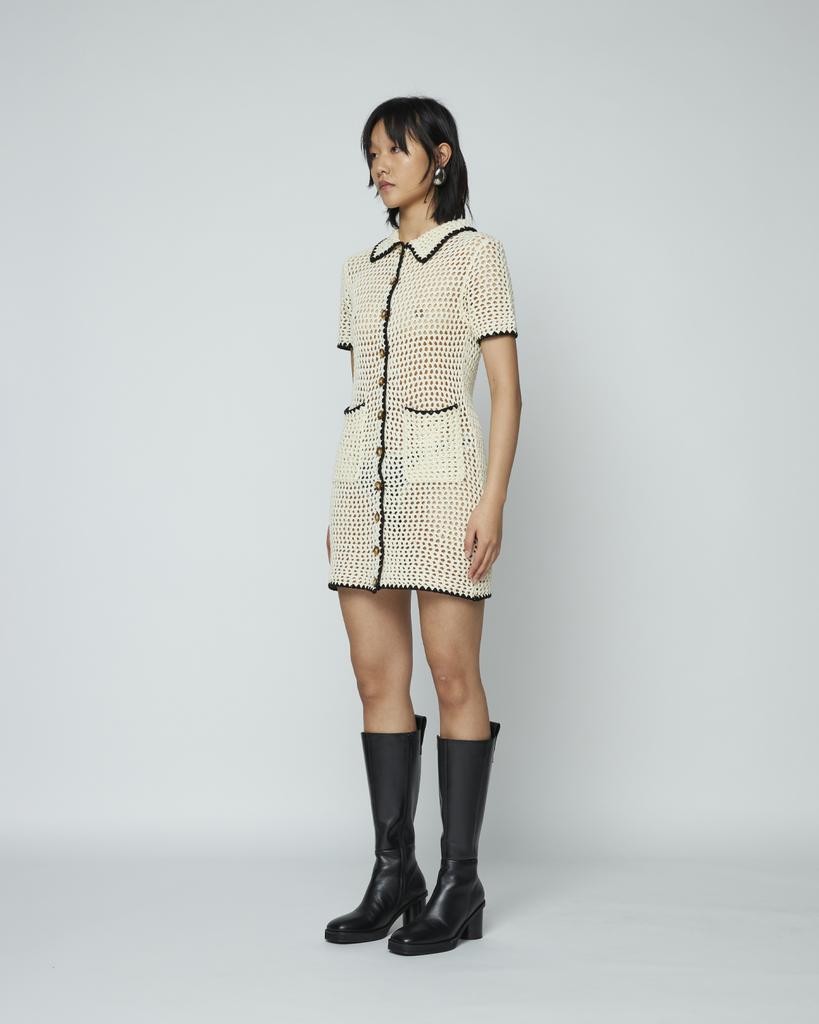 The Crochet Shirt Dress by Wynn Hamlyn is a short sleeve fitted mini dress with a spread collar. It features two front patch pockets, contrast detailing on collar, sleeve hem and down centre front and Wynn Hamlyn branded buttons. By Wynn Hamlyn, now available at After Eight. 