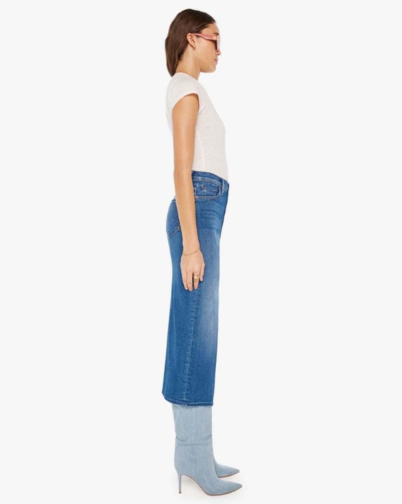 A denim pencil skirt with a high rise, narrow fit and a thigh-high front slit. Cut from stretch denim, Hue Are You? is a mid-blue wash with whiskering and subtle fading. By Mother Denim, now available at After Eight. 
