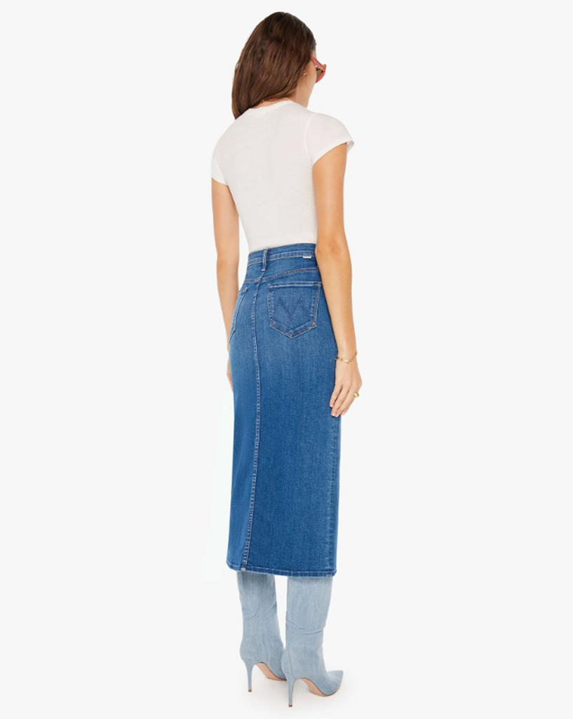 A denim pencil skirt with a high rise, narrow fit and a thigh-high front slit. Cut from stretch denim, Hue Are You? is a mid-blue wash with whiskering and subtle fading. By Mother Denim, now available at After Eight. 