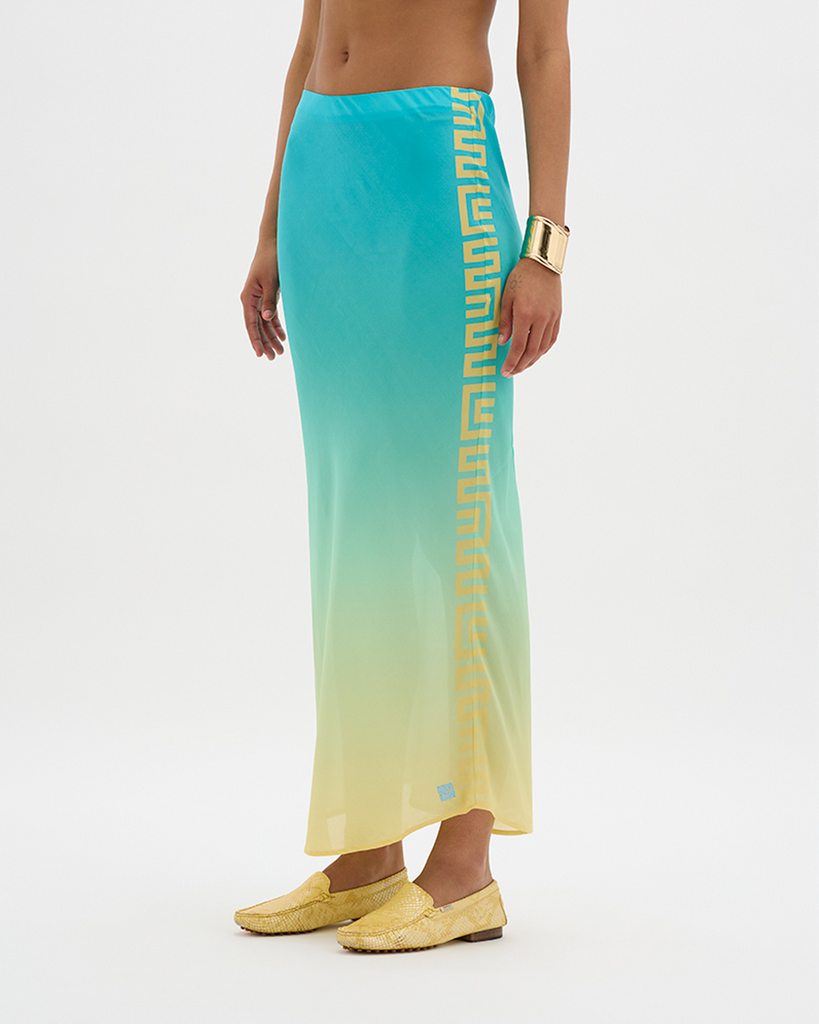 Expertly crafted in a silky vegan cupro blend, this bias-cut maxi skirt is ruched at the back and flows down an elongated hemline to the ankles, creating a timeless silhouette. The signature Muma panel along one side punctuates the gradient with asymmetrical structure, creating a nostalgic and luxurious feel. Simultaneously elegant and relaxed, the high-rise, thick-band elastication around the waist allows for movement, festivity, and indulgence all around. By Muma World, now available at After Eight. 