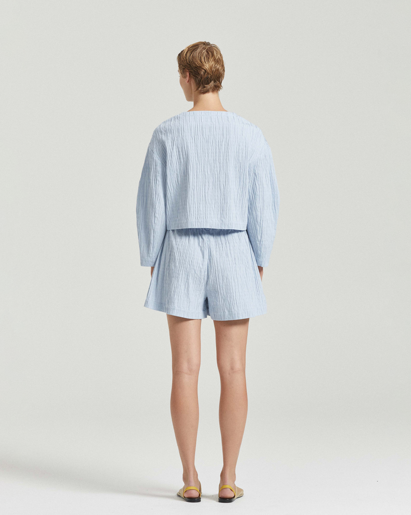 Endlessly wearable, the Suki Shorts are an easy pairing short designed to be lived in all summer long. Cut in a soft blue and white palette, it features a wide elastic waistband and side seam hem splits. By Friends with Frank, now available at After Eight. 