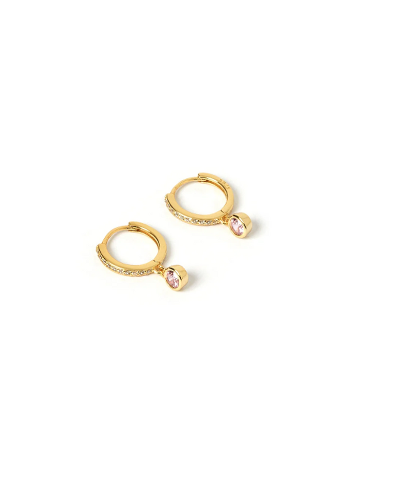 Add a touch of sparkle to your golden stack with our Rhodes Earrings. Cool and on trend, the classic stone hangs from a perfectly adorned hoop to make everyday earrings that will glam up your stack! By Arms of Eve, now available at After Eight. 