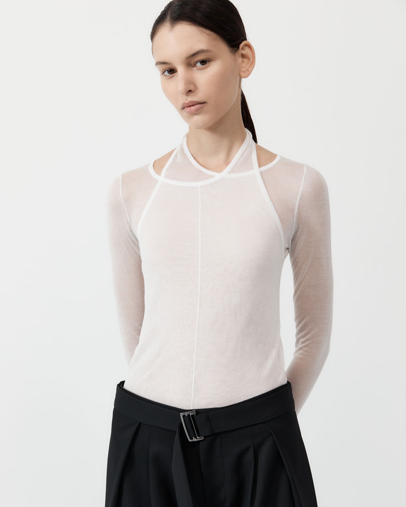 A playful take on the everyday long-sleeve, the Semi Sheer Loop Top boasts a layered halter neckline, long sleeve layered design and hip-length silhouette. Crafted from 100% TENCEL™ Lyocell for a semi sheer fabrication, the Semi Sheer Loop Top is a perfect trans-seasonal layering piece for the everyday capsule wardrobe. By St Agni, now available at After Eight. 