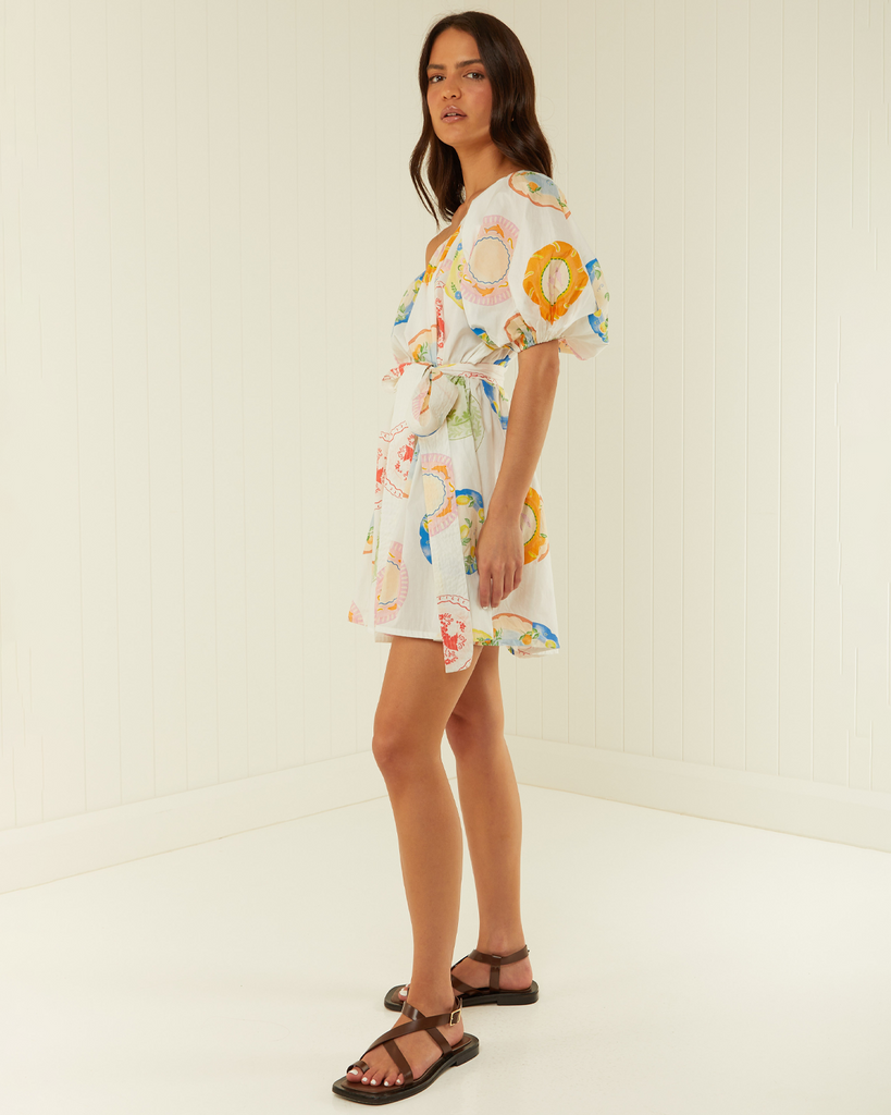 Sophisticated dressing takes shape in our Lotus Mini Dress. Featuring an asymmetric one-shoulder with voluminous sleeve detailing and a removable tie sash for added shape. The Lotus Mini is a fun event dress destined for a well-loved wardrobe. By Palm Noosa, now available at After Eight. 
