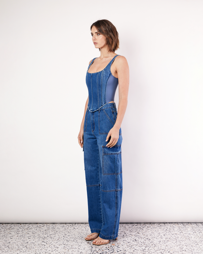 The Denim Cargo Pants are your go-to everyday denim jeans, featuring a relaxed straight leg with cargo pockets and unique front seam detailing. By Romy, now available at After Eight. 