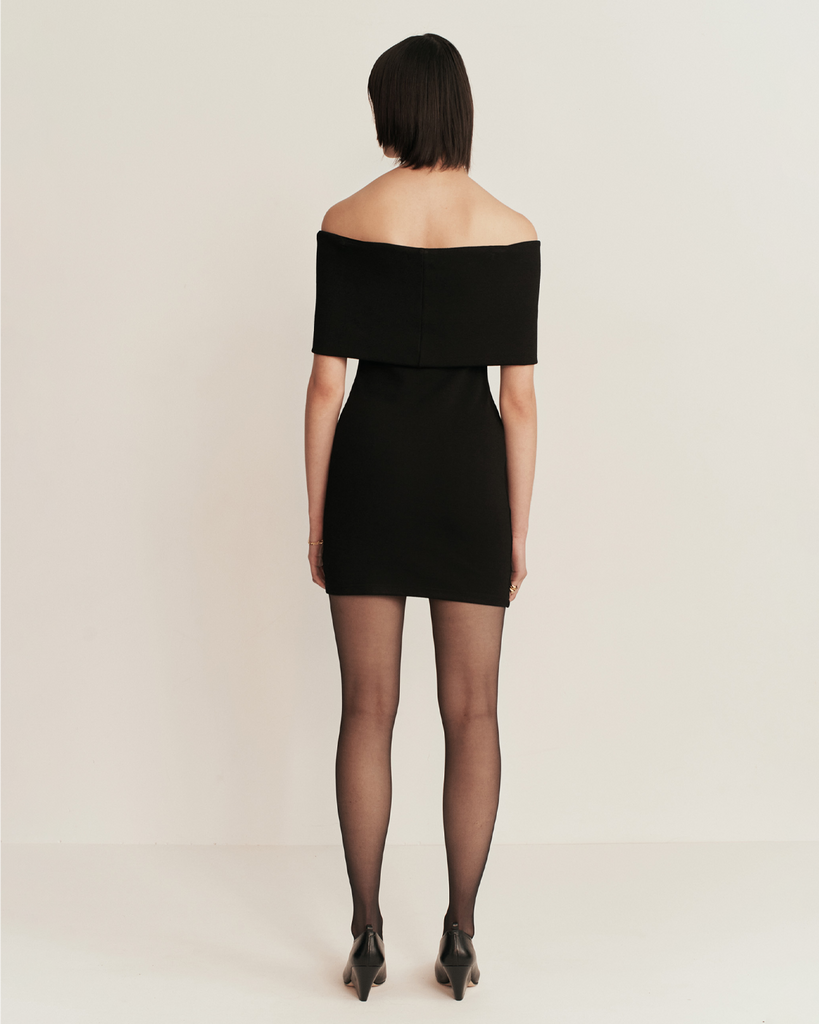 ESSE's latest knit series is the Omnia crepe fabric. A dense mid weight knit with a crepe texture. The mini dress features a folded band rolling over the shoulders with a body con body proportion. By Esse, now available at After Eight. 