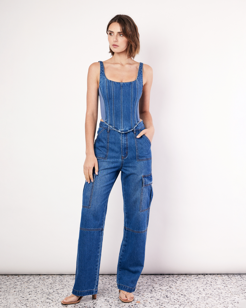 The Denim Bustier is a structured top, featuring adjustable straps, boning detail through the front, a zip closure and dipped waist to flatter your waistline. The side panels are made from scuba fabric that mould to the body and hug you in. By Romy, now available at After Eight. 