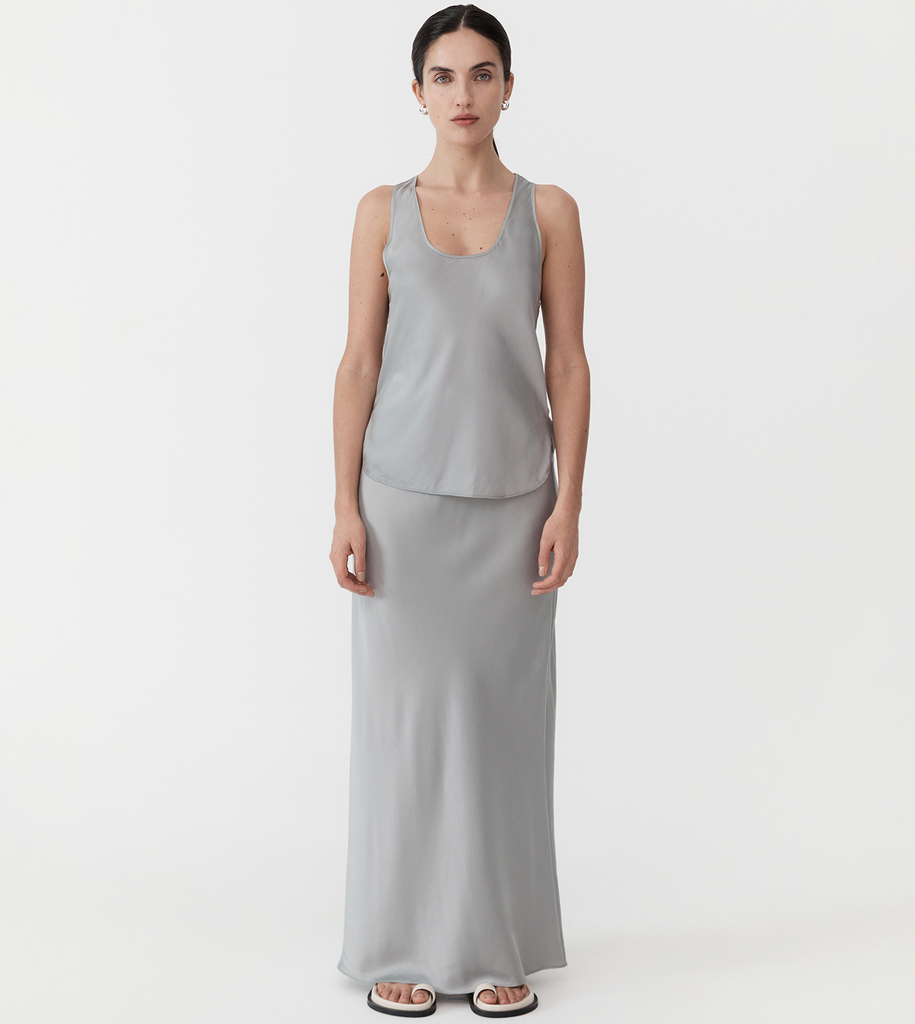 A sleek, slip-on-and-go number to dress up or down for daily wear. Boasting a racer-back style, curved hem with side splits, scooped U-neckline and crafted from the St Agni signature silk blend, the Racer Back Bias Tank is ideal for minimalist style with maximal impact. By St Agni, now available at After Eight. 