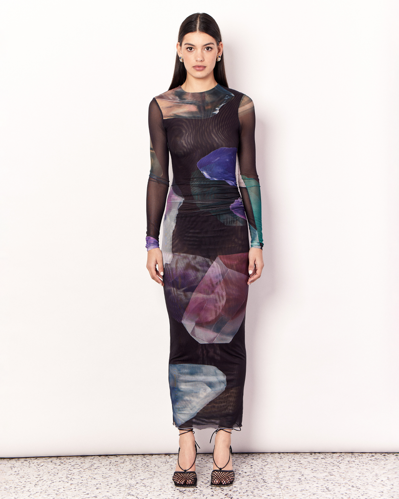 The Gemstone Long Sleeve Mesh Maxi Dress is an elegant and figure hugging silhouette. It is crafted with an ultra-soft mesh fabrication that is opaque through the body and sheer through the arms in the opulent Gemstone Print, designed exclusively for Romy. By Romy, now available at After Eight. 