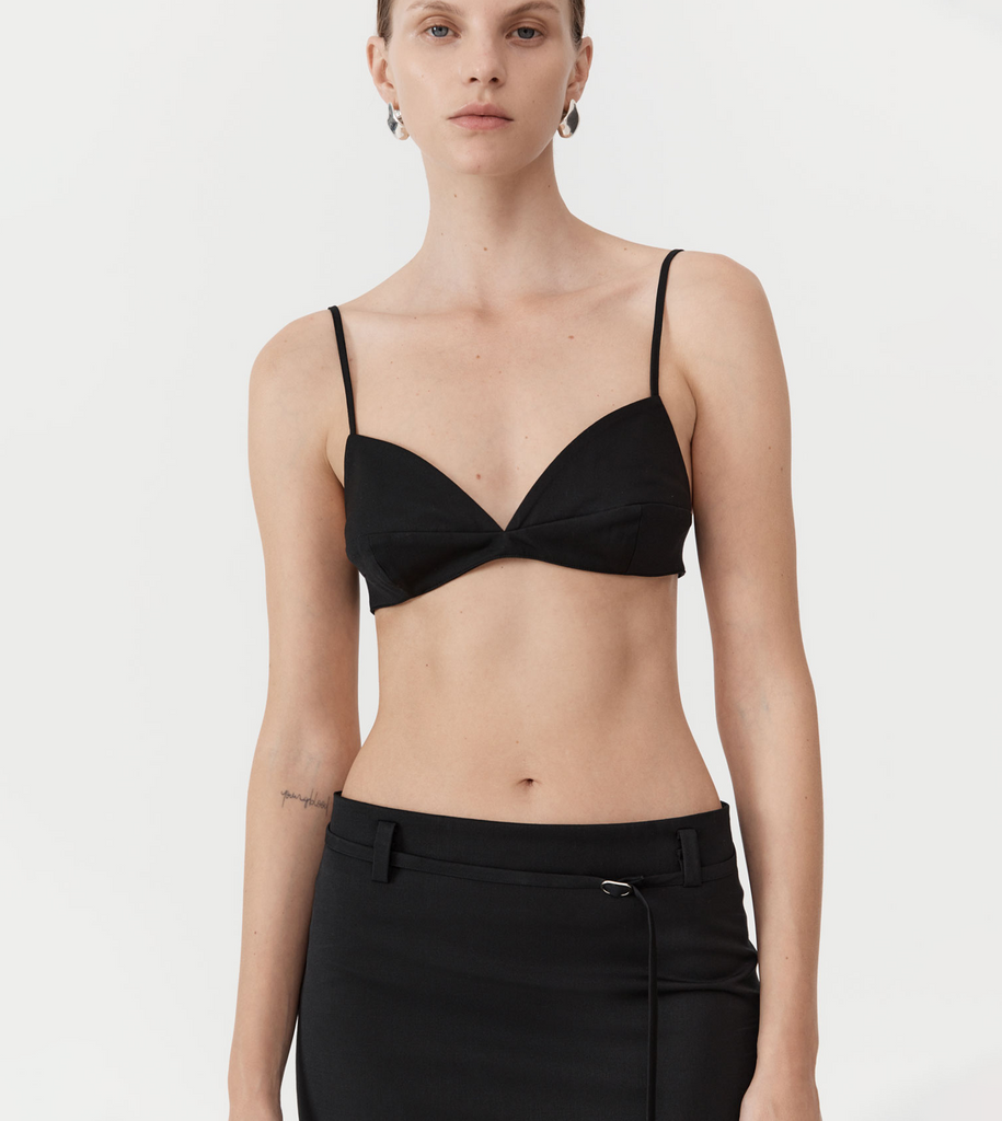 Crafted from the St Agni signature responsibly sourced wool blend, the Utilitarian Bralette boasts a panelled cup, adjustable lingerie hook at the back and spaghetti straps. Designed to be layered for a subtly flirtatious and classically feminine feel, the Utilitarian Bralette is a structured undergarment option to pair with the Utilitarian Brief or layered underneath a sheer top. By St Agni, now available at After Eight. 