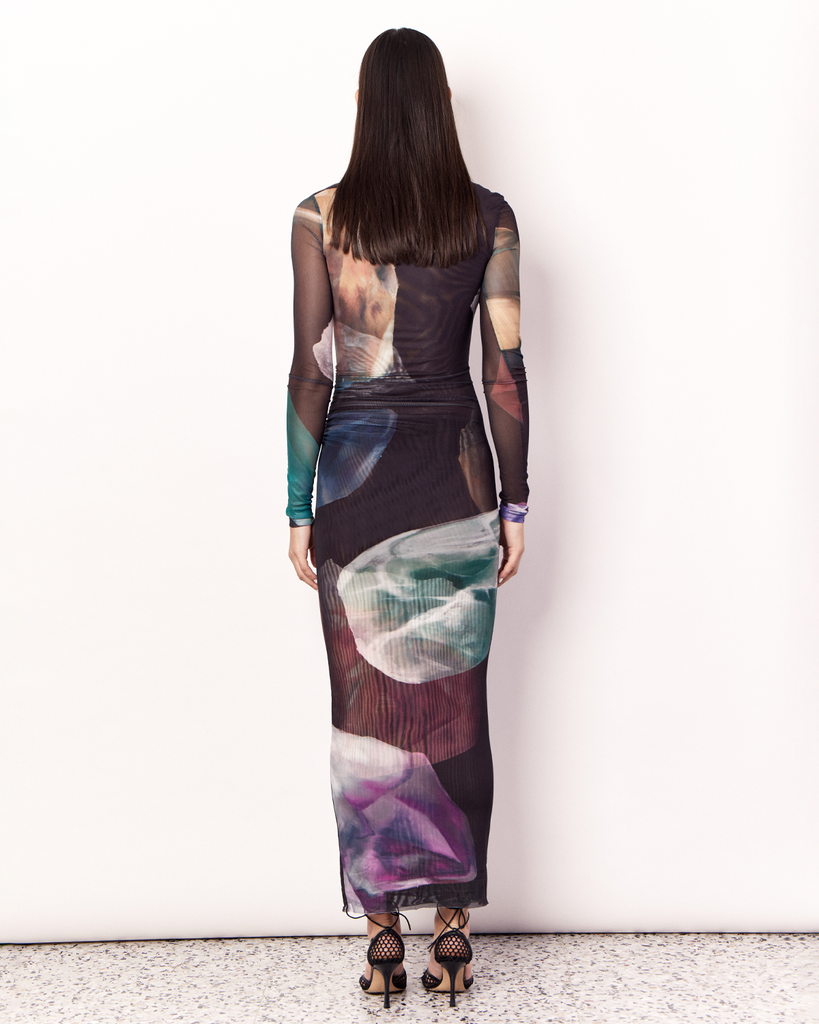 The Gemstone Long Sleeve Mesh Maxi Dress is an elegant and figure hugging silhouette. It is crafted with an ultra-soft mesh fabrication that is opaque through the body and sheer through the arms in the opulent Gemstone Print, designed exclusively for Romy. By Romy, now available at After Eight. 