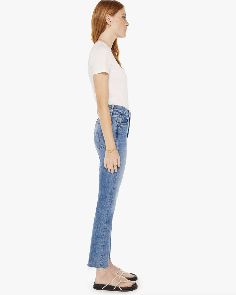 High-rise jeans with a straight leg, button fly, ankle-length inseam and a frayed hem. Cut from denim with a touch of stretch, On The Road is a mid-blue wash with whiskering and fading throughout. By Mother Denim, now available at After Eight. 