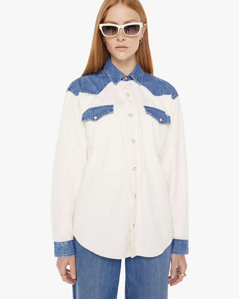 A Western-inspired denim button-up with patch pockets, a curved hem, and snaps down the front. Made from 100% cotton, the Tycoon in Shoulder To Shoulder is designed in off white with denim details at the shoulders, pockets and wrists. By Mother Denim, now available at After Eight. 