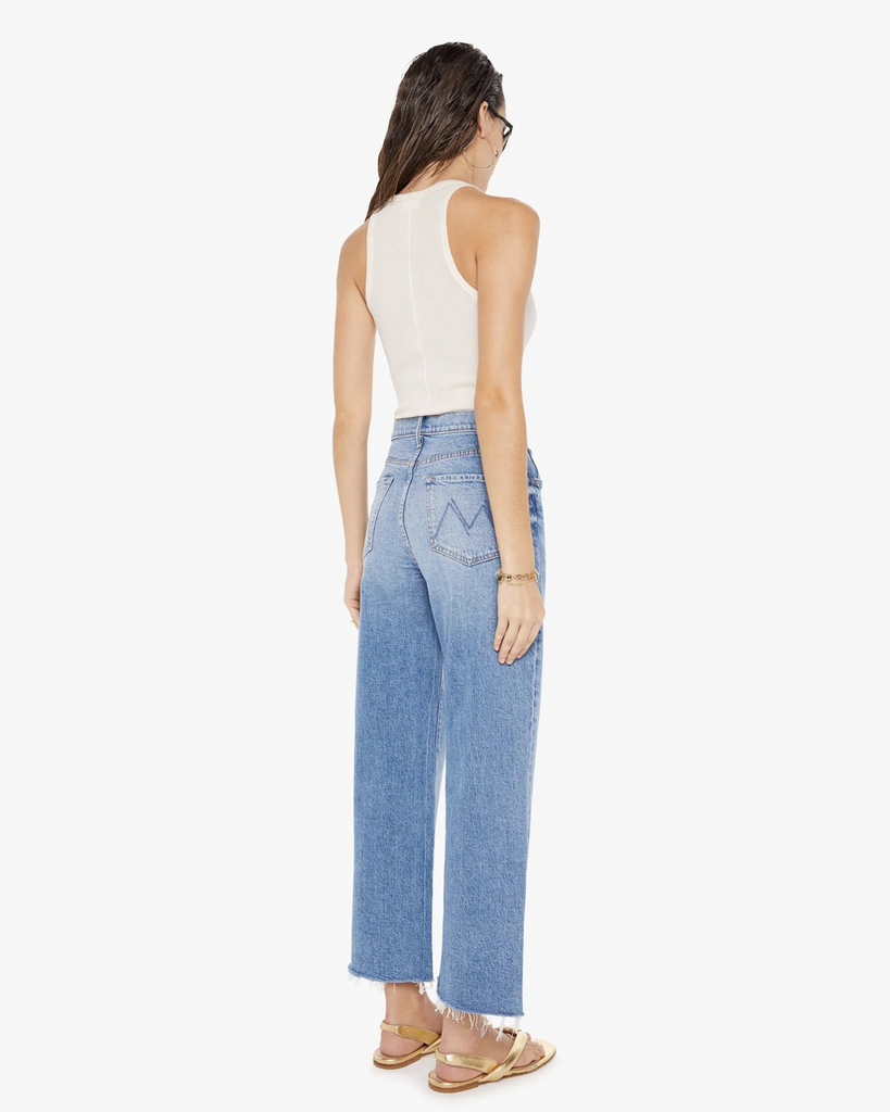 Super high-waisted jeans with a loose fit, wide leg and an ankle-length inseam with a frayed hem. Made from denim with a touch of stretch, For Sure is a mid-blue wash with whiskering and fading at the knee. By Mother Denim, now available at After Eight. 