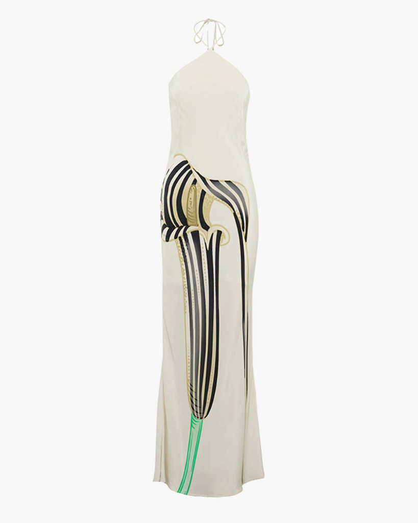 Introducing a seasonal feature piece, the Cobra Lilly Halter Maxi Dress. A thin tie around the neck with custom-designed end-weights, the dress drapes down the back and to the floor in a show-stopping bias-cut silhouette, ensuring it suits any figure with ease. By Muma World, now available at After Eight. 