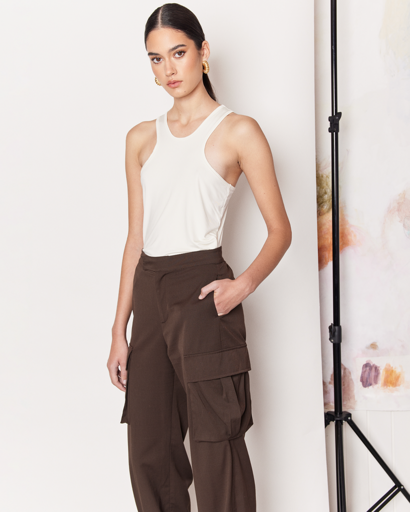 The Cargo Pants offer a modern twist on the 90s Cargo Pant with a parachute silhouette in a rich chocolate brown colour-way. Whether you are runnings errands or heading out for dinner, these pants provide ultimate comfort all day long and are a great addition to your wardrobe. Pair with a basic tee or tank for everyday wear. By Romy, now available at After Eight. 