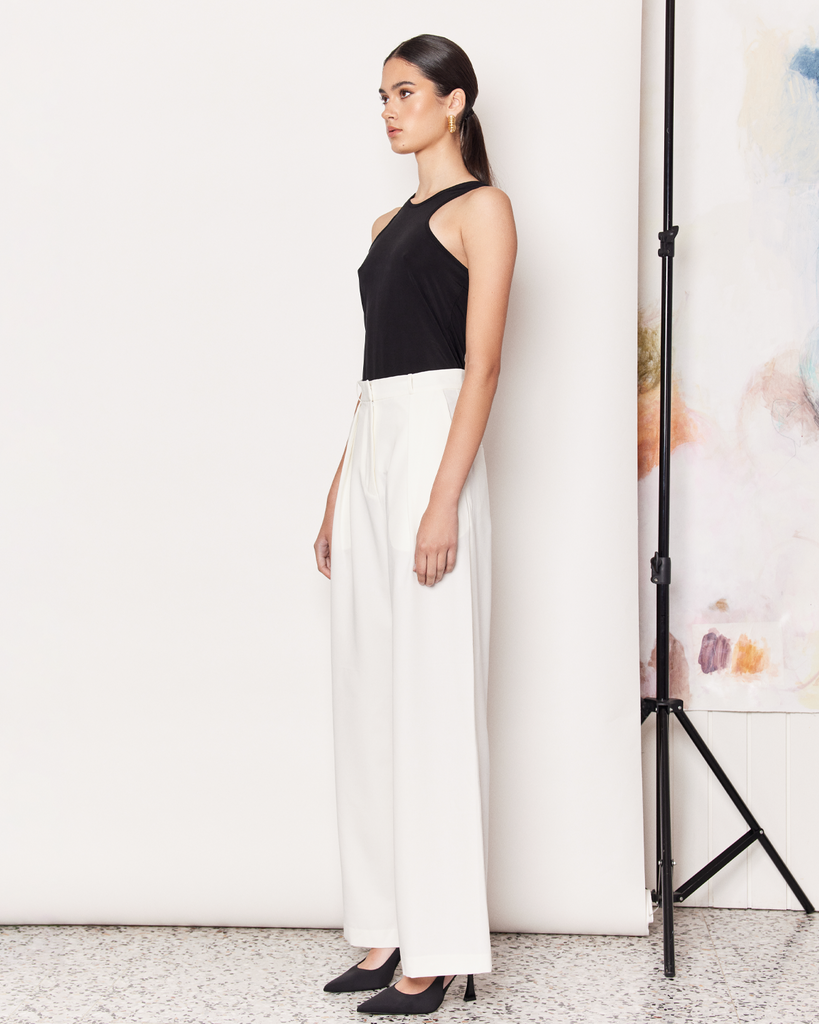 The Racer Stretch Tank is an endlessly versatile wardrobe staple crafted from a durable and silky smooth Cupro fabrication in white. A wardrobe essential that can be paired with anything from a tailored trouser to a mini skirt, to your everyday activewear. By Romy, now available at After Eight.