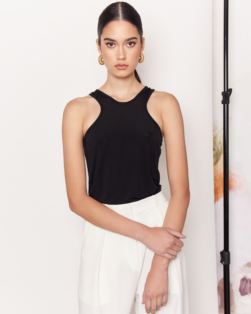 The Racer Stretch Tank is an endlessly versatile wardrobe staple crafted from a durable and silky smooth Cupro fabrication in white. A wardrobe essential that can be paired with anything from a tailored trouser to a mini skirt, to your everyday activewear. By Romy, now available at After Eight.